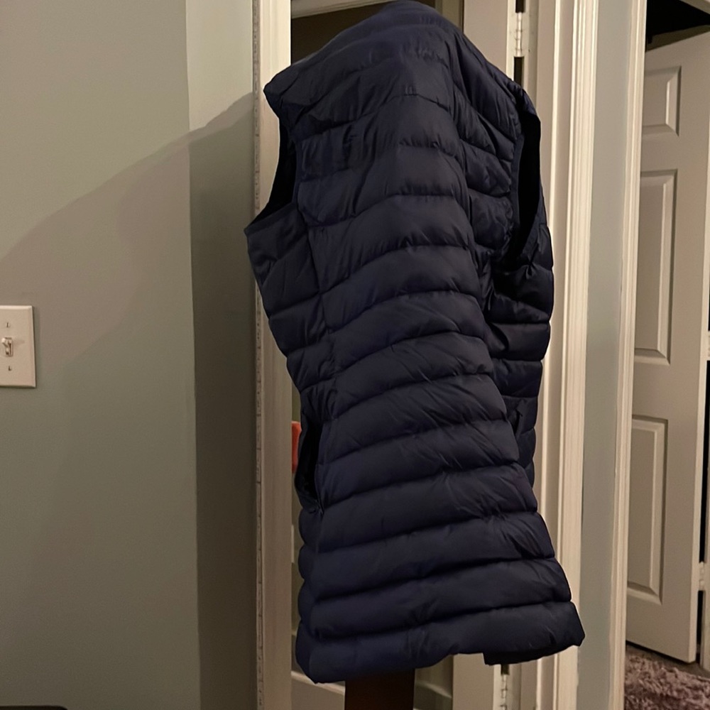 LANDS’ END thin puffer vest with length and shape at the waist.